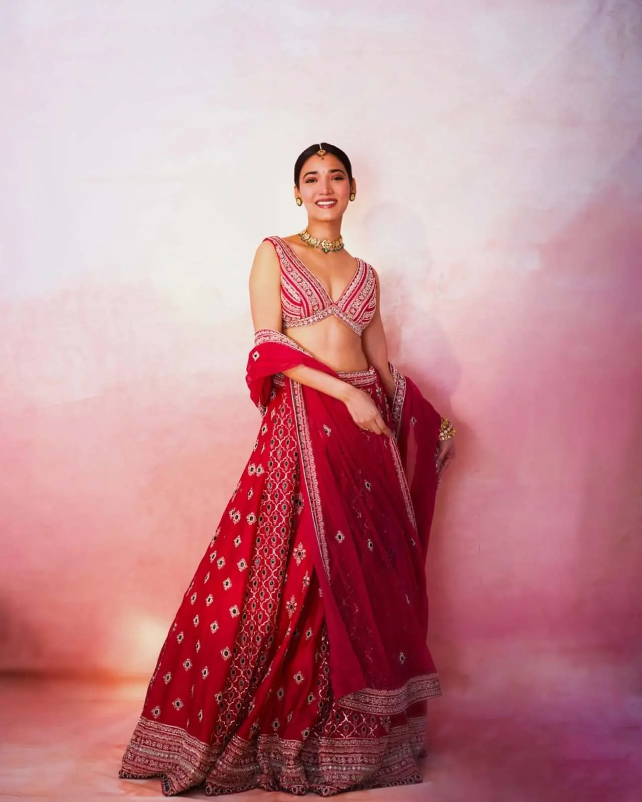Medha Shankr serves traditional elegance at the Ginny Wedss Sunny 2 trailer launch in this striking red lehenga set, intricately detailed with ivory and silver mirror-work embroidery.